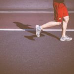 person running on concrete road